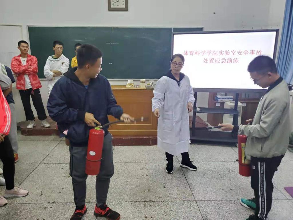 图4 唐丽副教授为同学们讲解灭火器等消防设施的使用